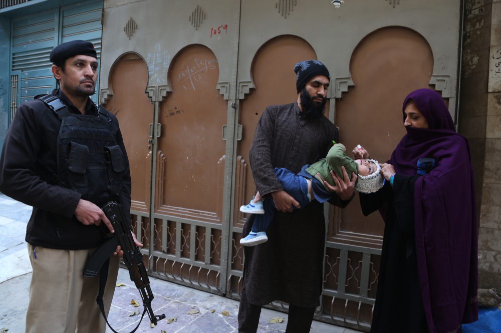 Suspected militants kill 2, including a police officer guarding polio team in northwestern Pakistan