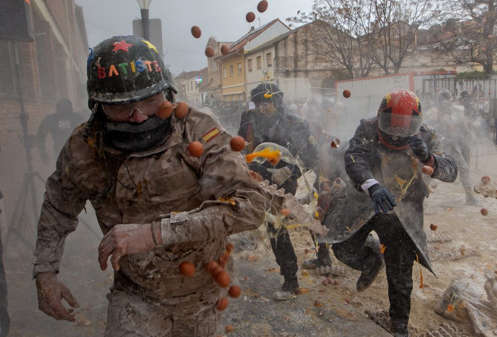 Photos show flour, eggs and firecrackers flying at Spain’s Els Enfarinats festival