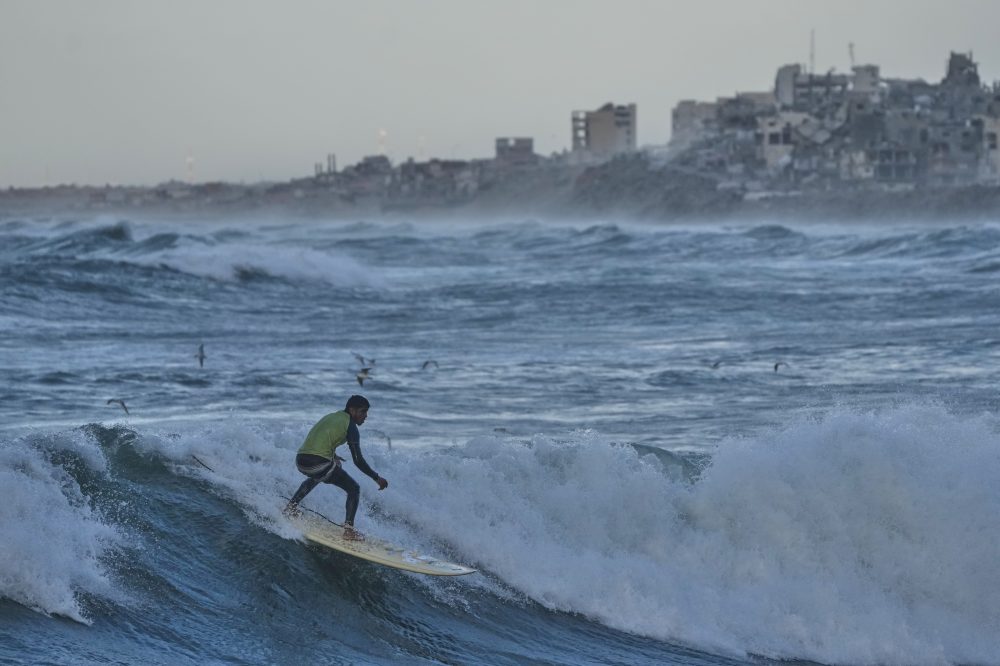 Photos show surfers riding waves along Gaza City’s damaged coastline