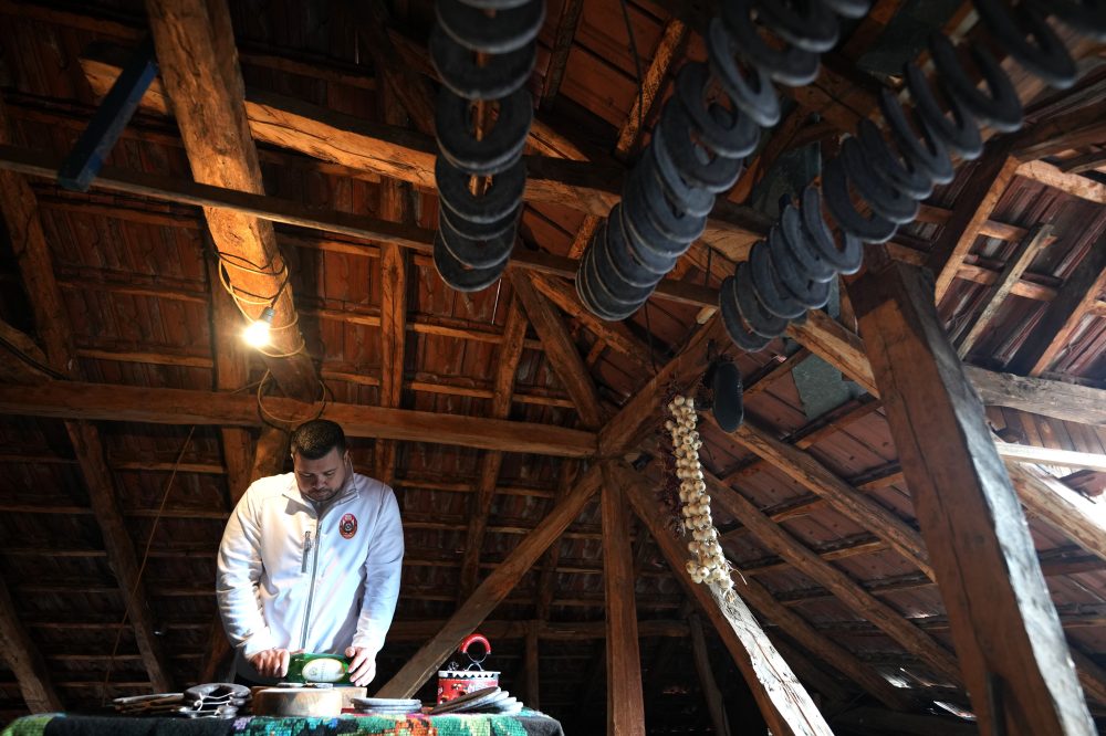 A traditional sausage in the shape of a horseshoe is ‘ironed’ for dryness in southeastern Serbia
