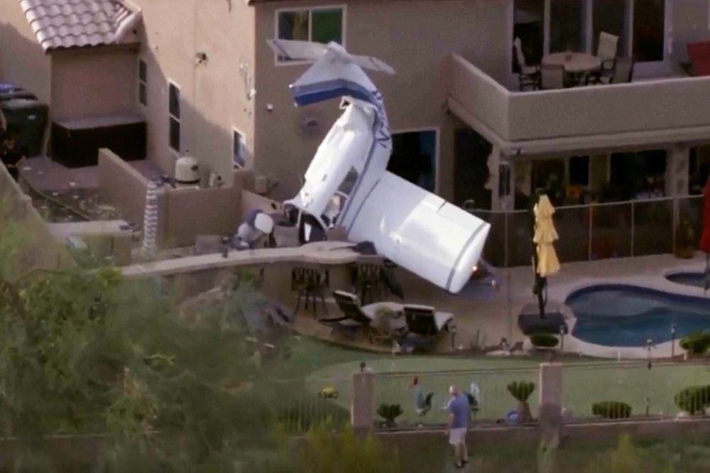 Small plane strikes homes in Phoenix and crashes nose-down next to backyard pool, injuring 3