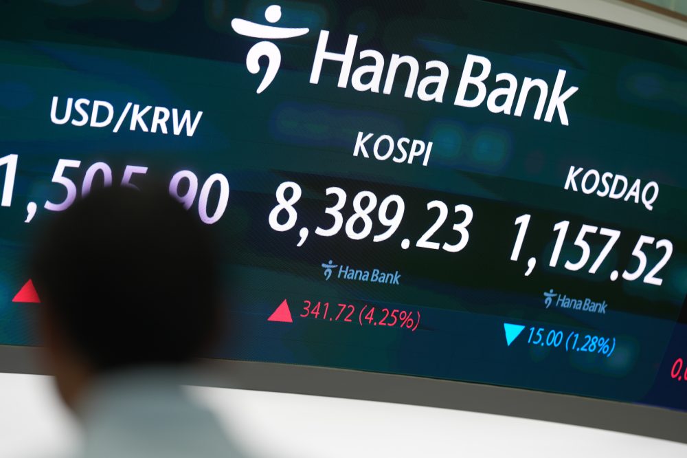 Asian shares are mostly higher, tracking Wall Street’s fresh records, and oil prices fall