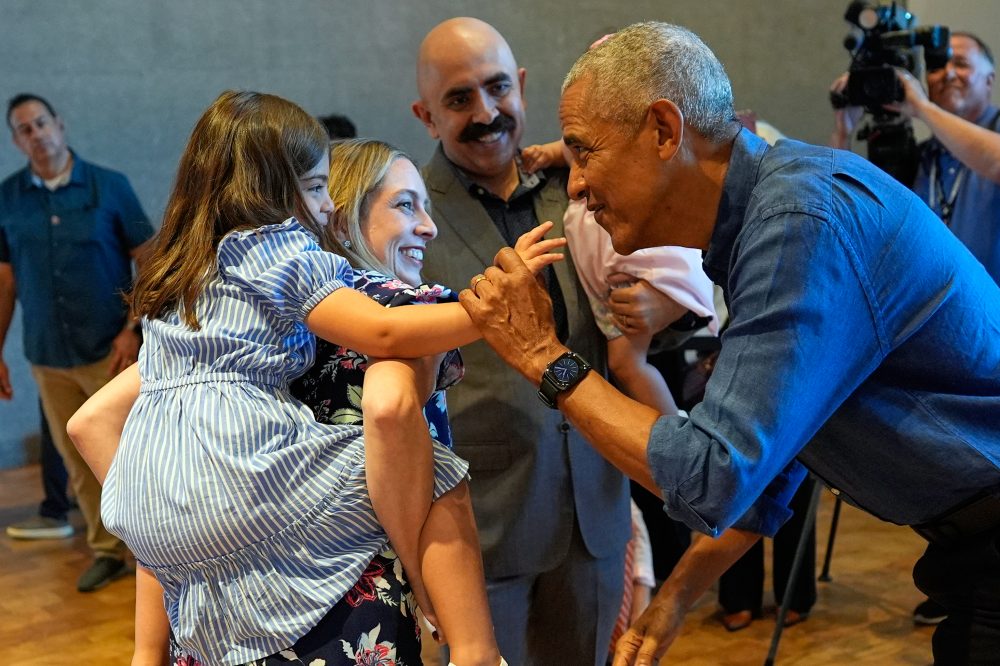 Barack and Michelle Obama surprise first visitors to newly opened presidential center