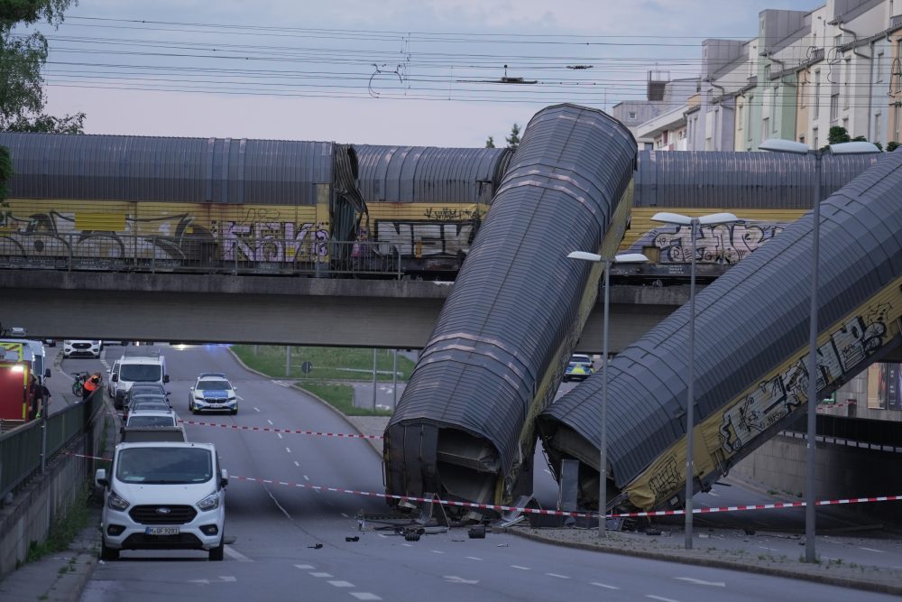 A freight trains’ collision in Germany sends 2 wagons plunging off a bridge. One person was killed