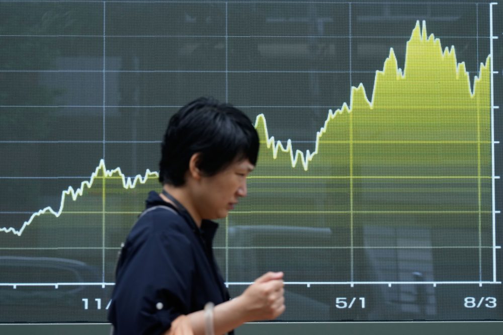 Asian shares are mostly higher while US futures and oil prices hold steady