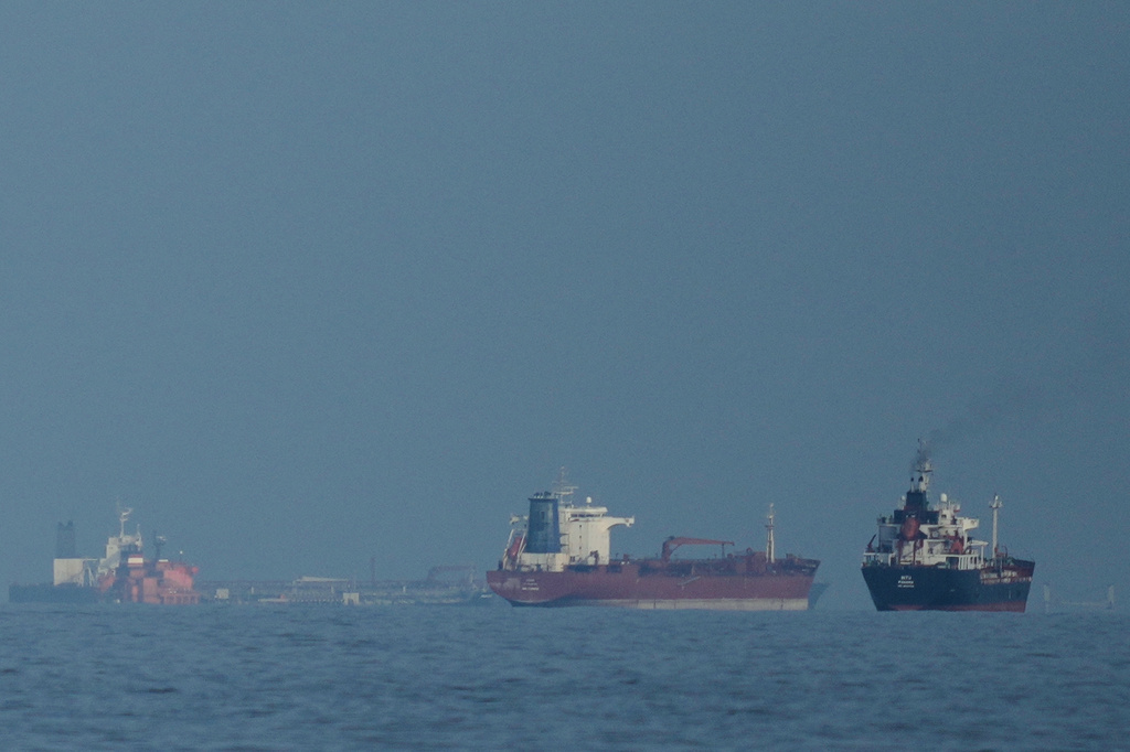 Cargo ship reports being struck in Strait of Hormuz as US, Iran claims about talks diverge