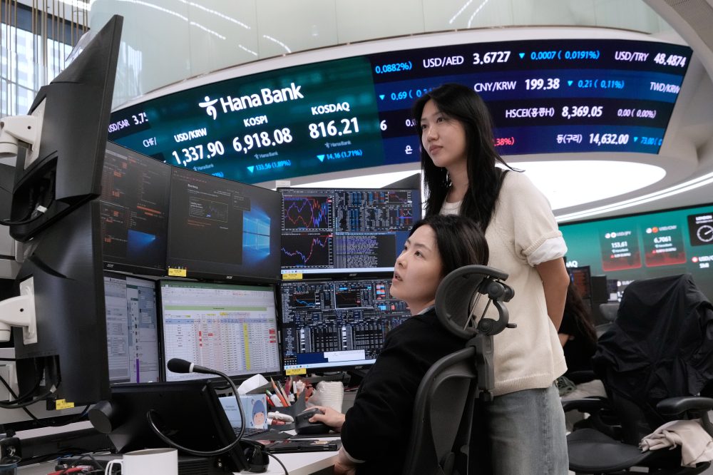 Asian shares fall and oil prices hold steady above $100 a barrel